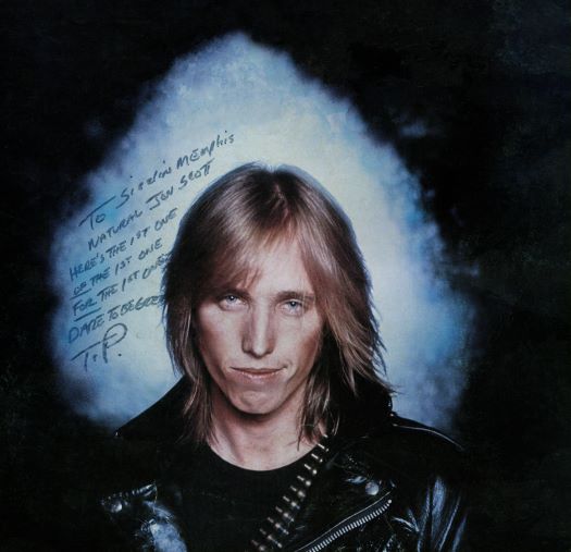 Tom Petty's signed message to Jon Scott. Tom Petty and the Heartbreakers original cover photo of band's first album. Courtesy of Ed Caraeff and Iconic Images.